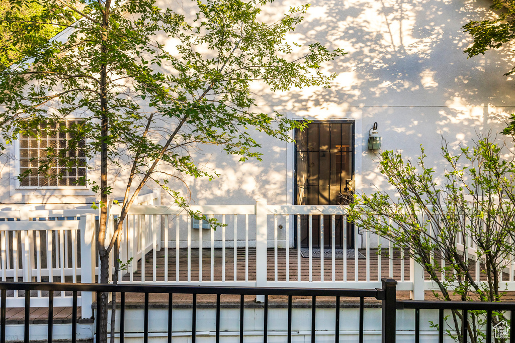 View of exterior entry featuring stucco siding and a gate