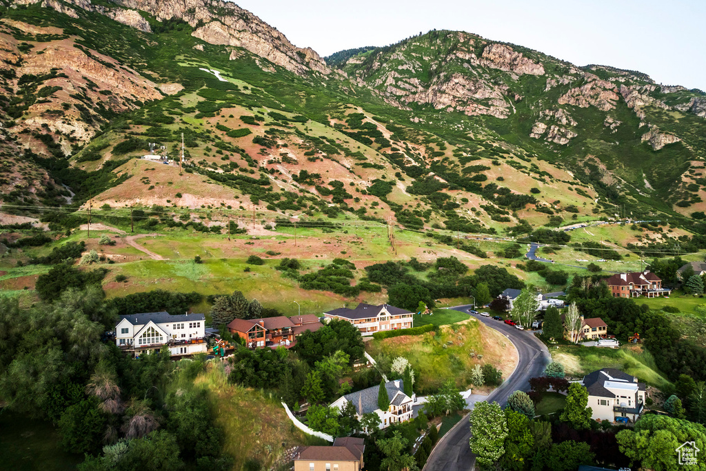 Aerial view of property and surrounding area featuring a mountain backdrop
