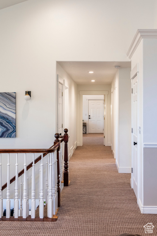 Corridor featuring carpet, baseboards, recessed lighting, and an upstairs landing