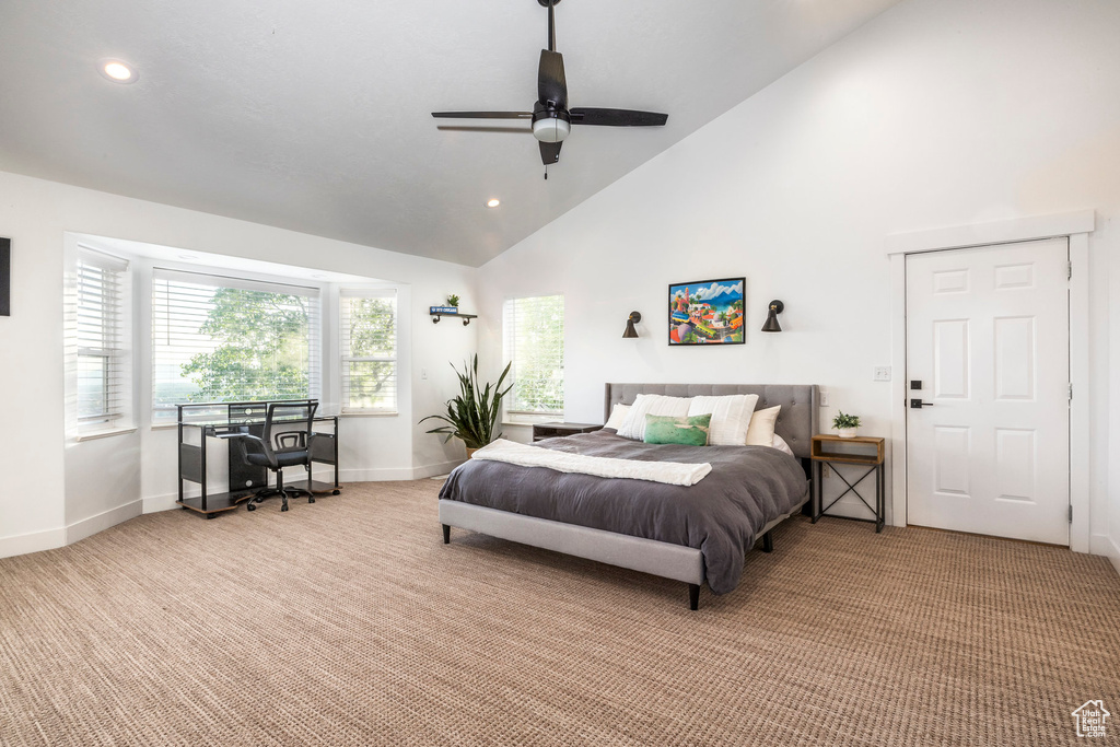 Bedroom featuring light colored carpet, high vaulted ceiling, baseboards, recessed lighting, and an office area