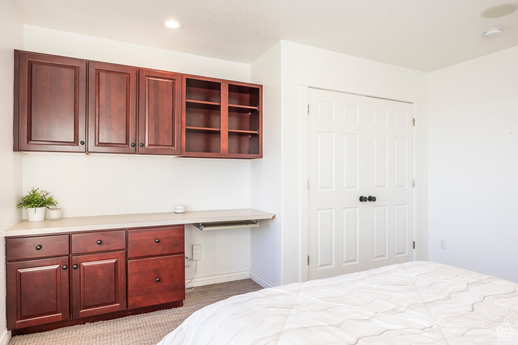 Carpeted bedroom with baseboards and recessed lighting