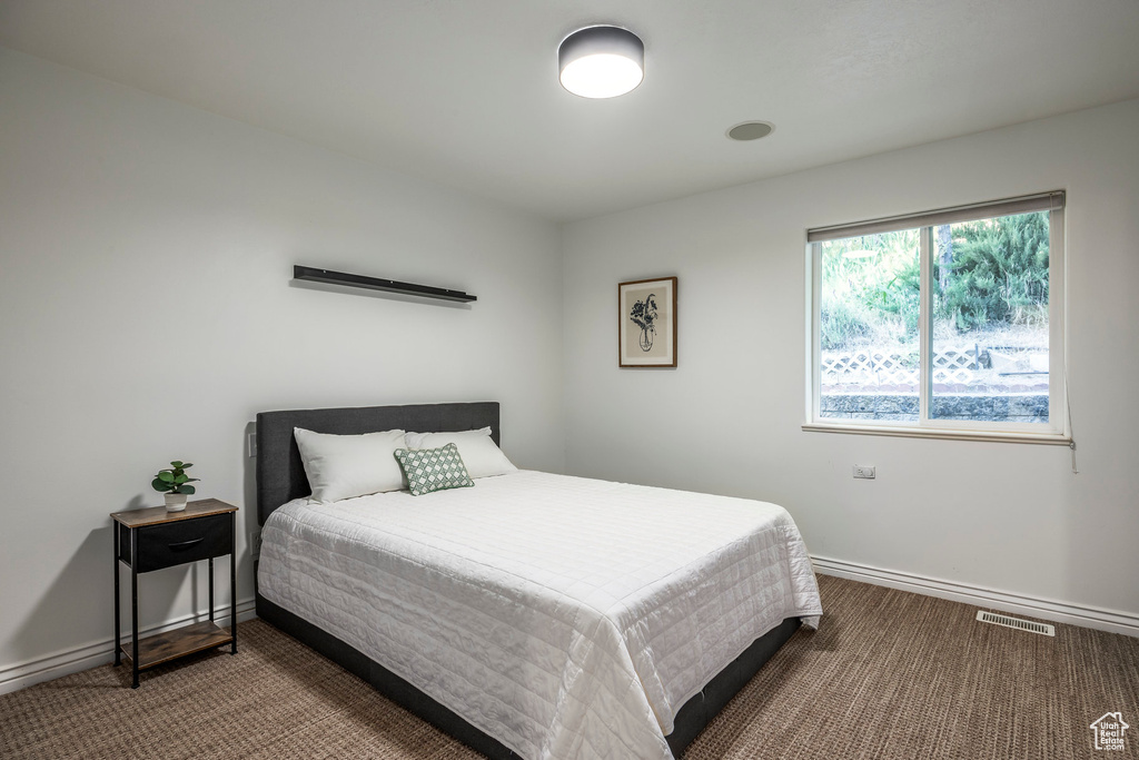 Bedroom with baseboards and carpet flooring
