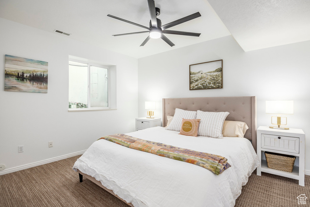 Bedroom with carpet floors, baseboards, and a ceiling fan