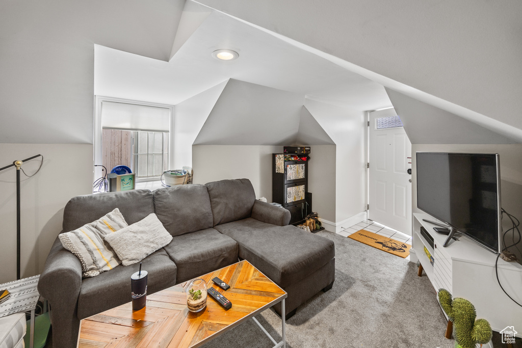 Living room featuring lofted ceiling, recessed lighting, and baseboards