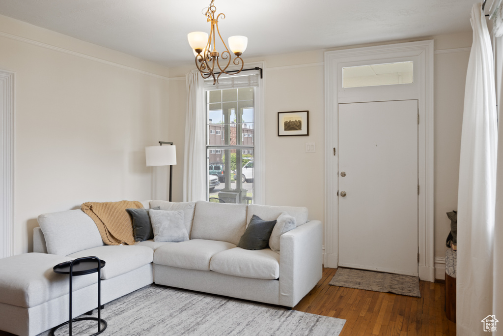 Living area featuring wood finished floors and a chandelier