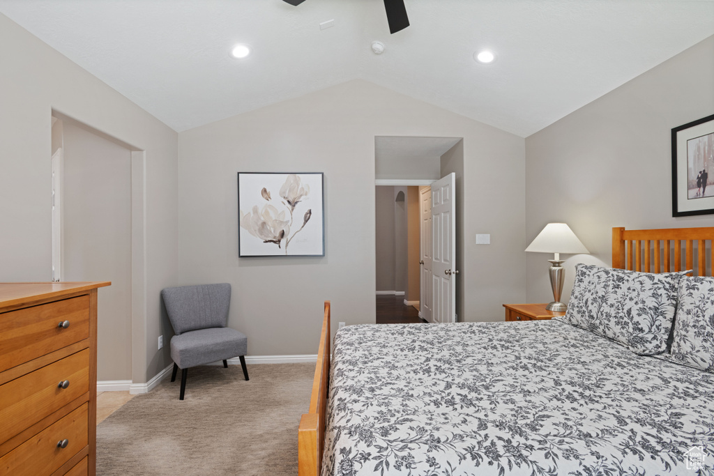 Bedroom featuring light colored carpet, lofted ceiling, baseboards, recessed lighting, and ceiling fan