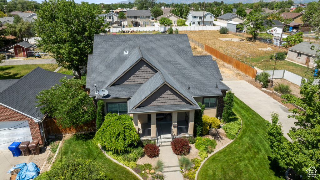 View of front facade featuring a residential view and roof with shingles