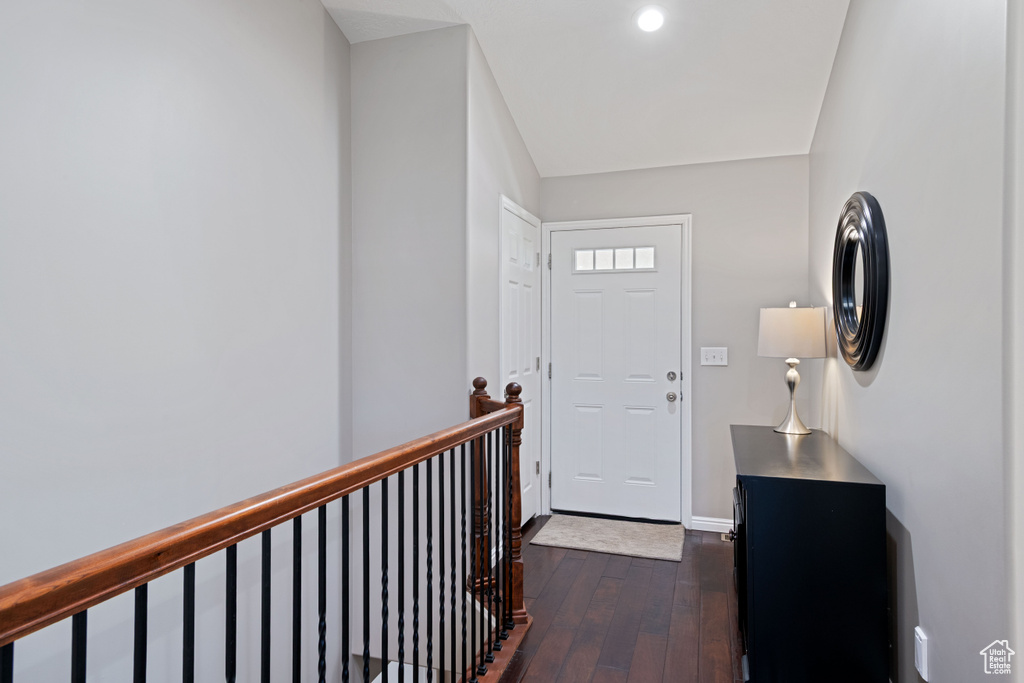 Entryway featuring dark wood-style floors, baseboards, and recessed lighting