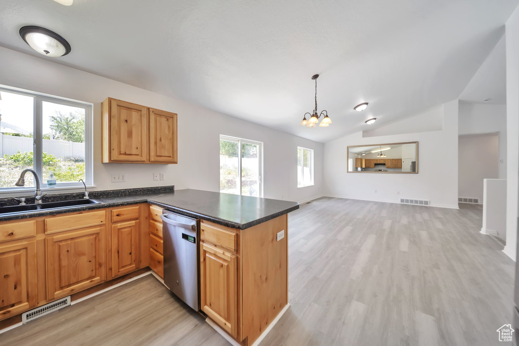 Kitchen with dishwasher, a sink, light wood-type flooring, vaulted ceiling, and a chandelier