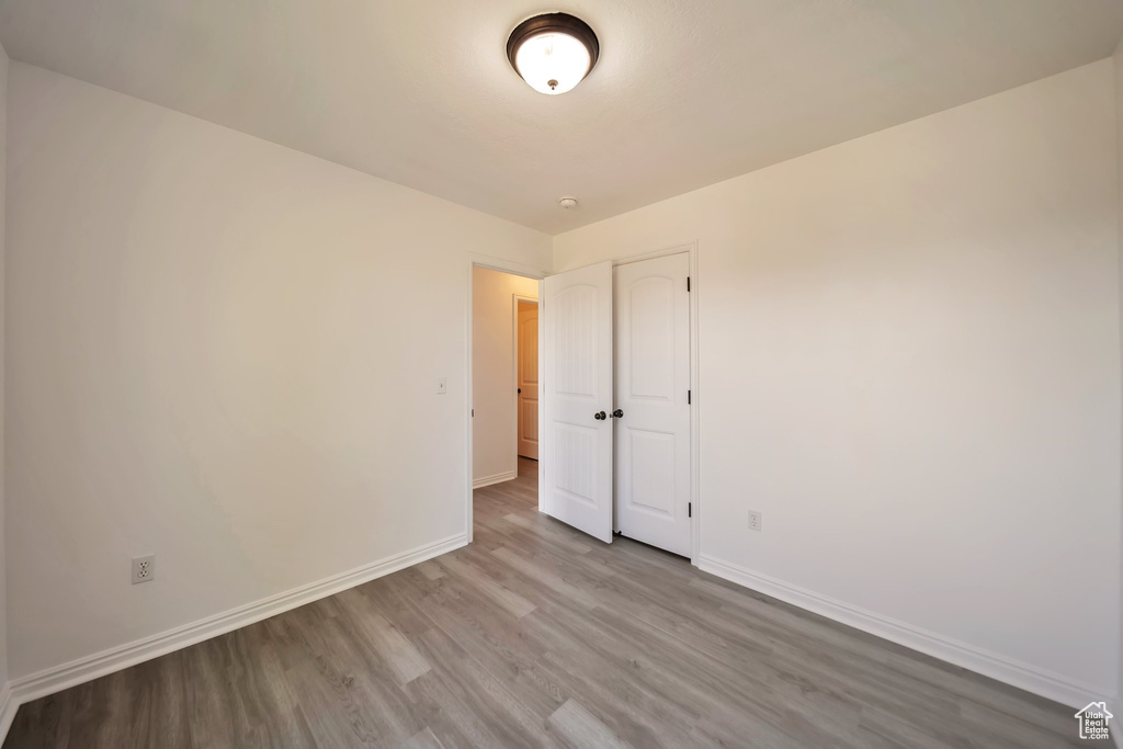 Empty room with wood finished floors and baseboards