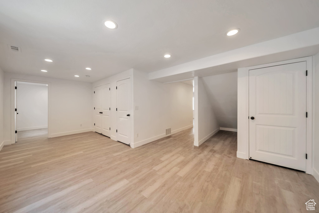 Finished basement featuring recessed lighting, baseboards, and light wood-style flooring