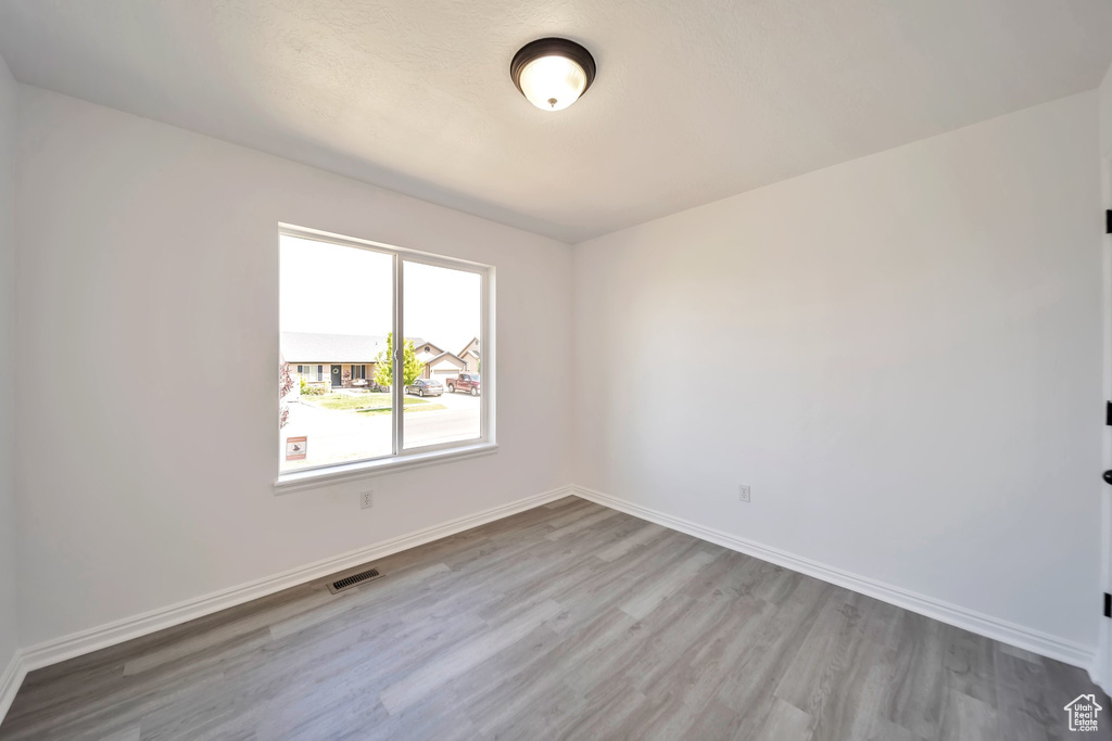 Empty room featuring wood finished floors and baseboards