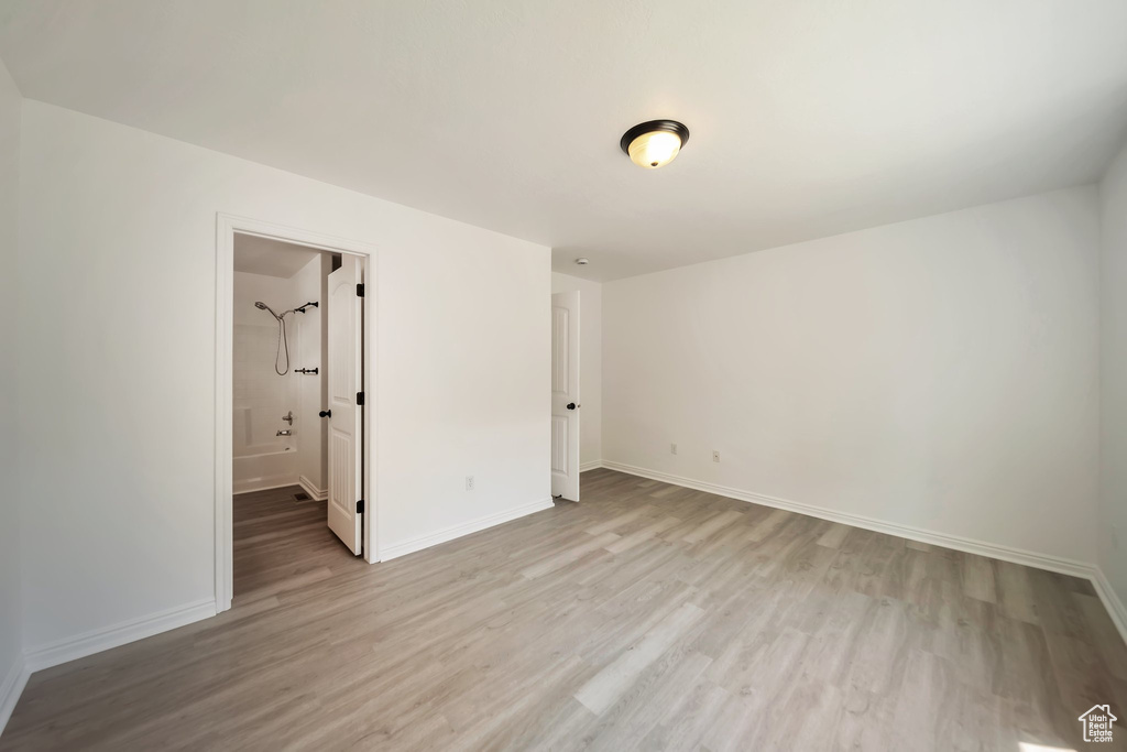 Unfurnished bedroom featuring light wood-style floors and baseboards