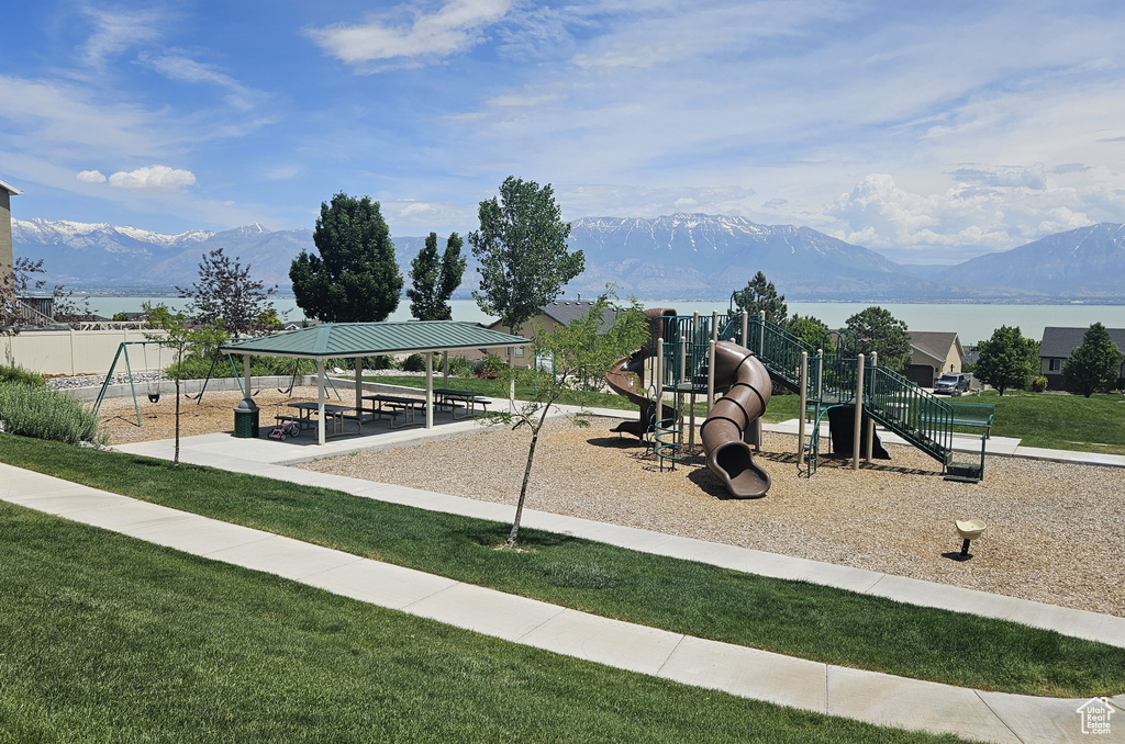 Community jungle gym with a mountain view, a gazebo, and a lawn