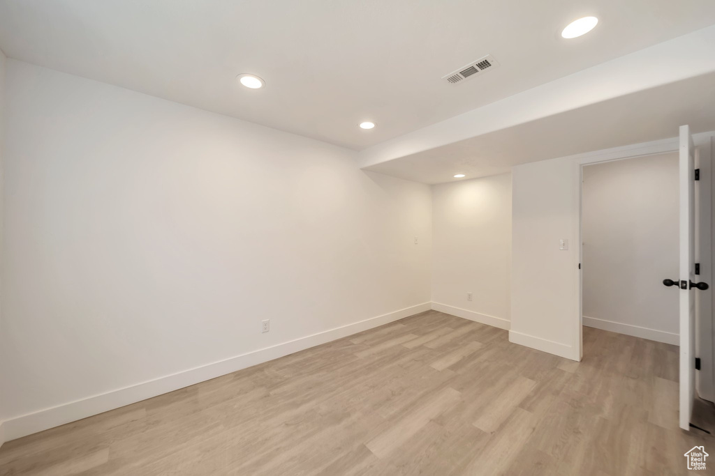 Finished basement featuring light wood finished floors, baseboards, and recessed lighting