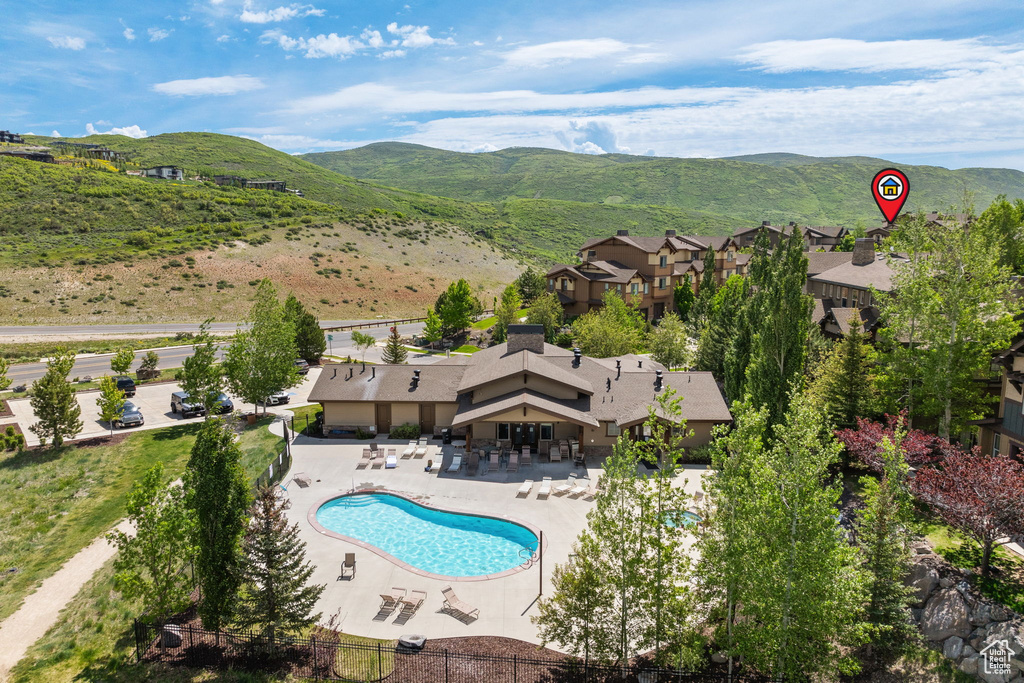 Aerial view of a mountainous background and a pool