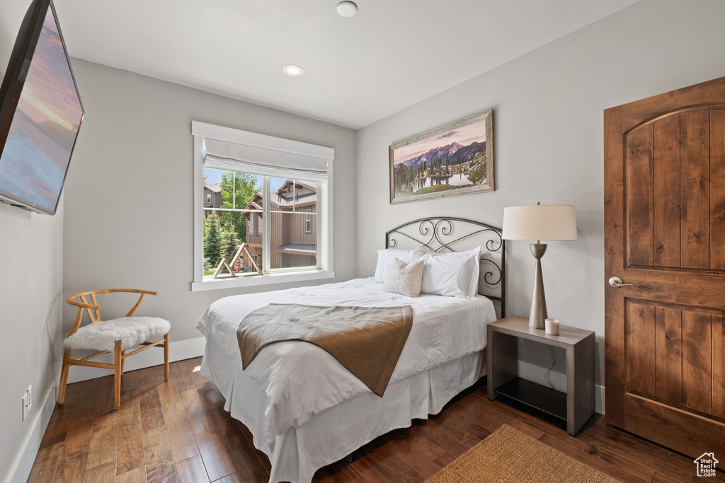 Bedroom with wood-type flooring, baseboards, and recessed lighting