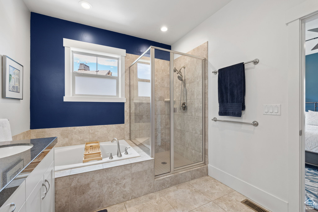 Ensuite bathroom with a garden tub, tile patterned flooring, a stall shower, vanity, and recessed lighting