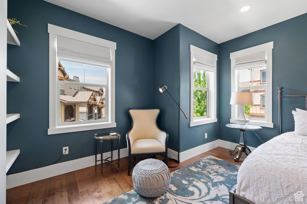 Bedroom with baseboards and wood finished floors