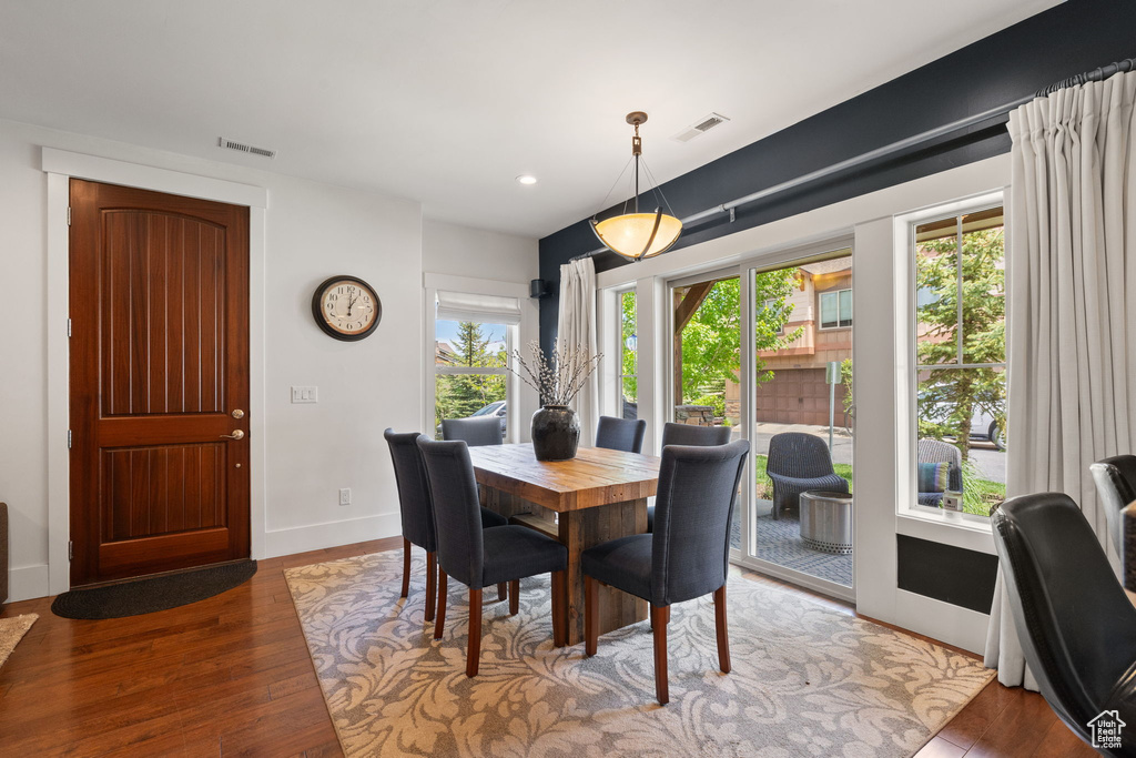 Dining room featuring wood finished floors, baseboards, and recessed lighting