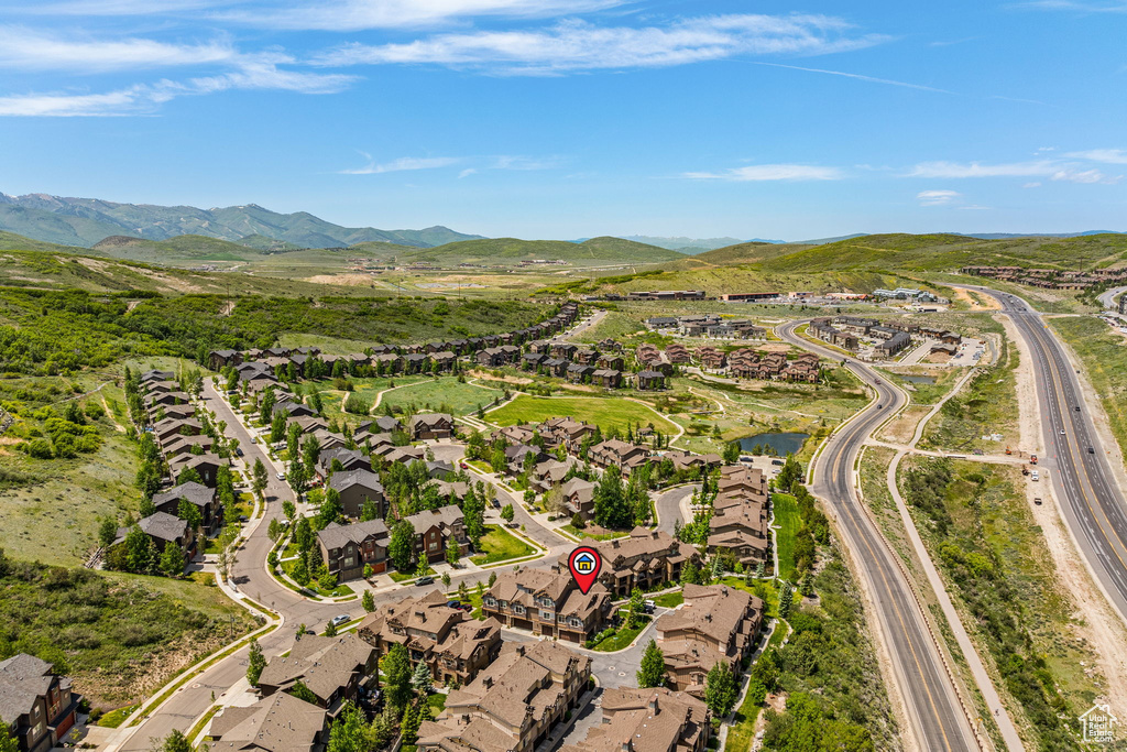 Aerial view of residential area with a mountain backdrop and a major roadway