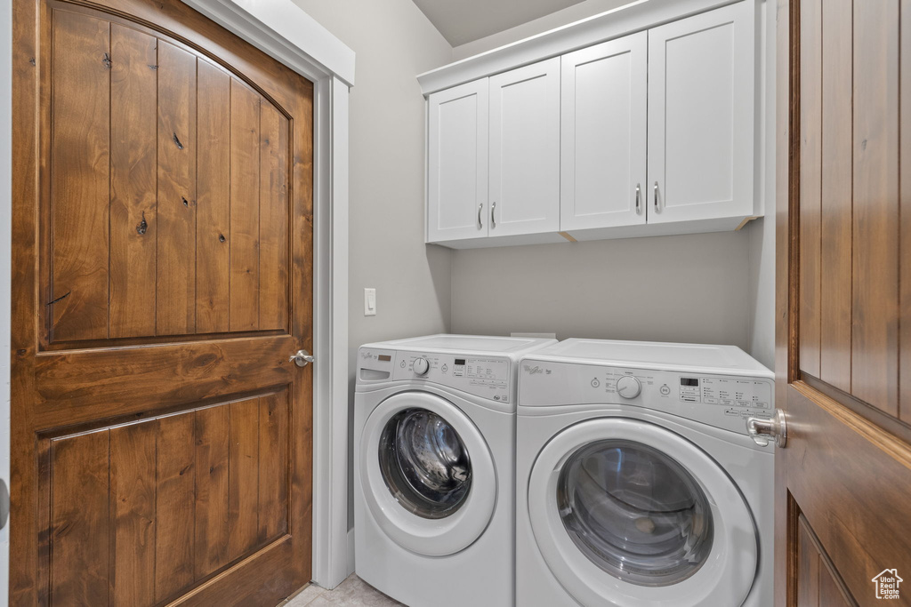 Laundry room with washing machine and dryer and cabinet space