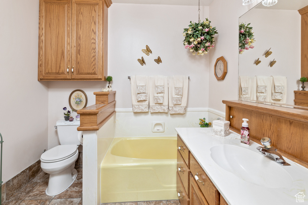 Bathroom with a bath, toilet, and vanity
