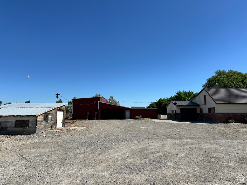 View of side of property with an outbuilding and a garage