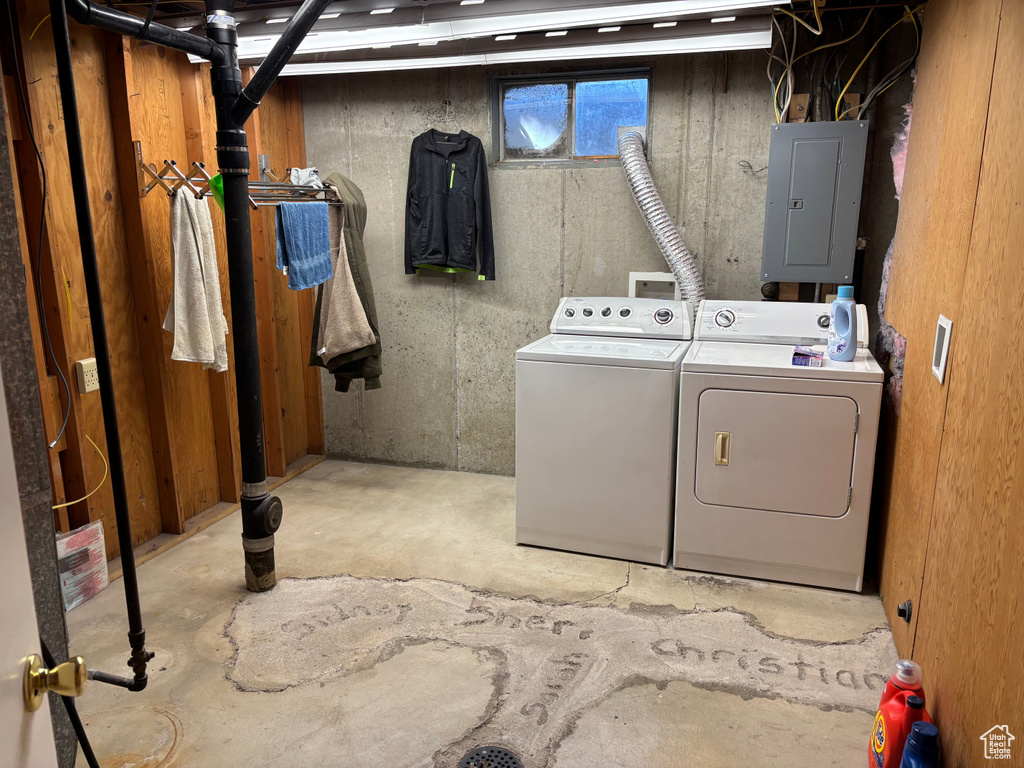 Laundry room featuring electric panel and washing machine and clothes dryer