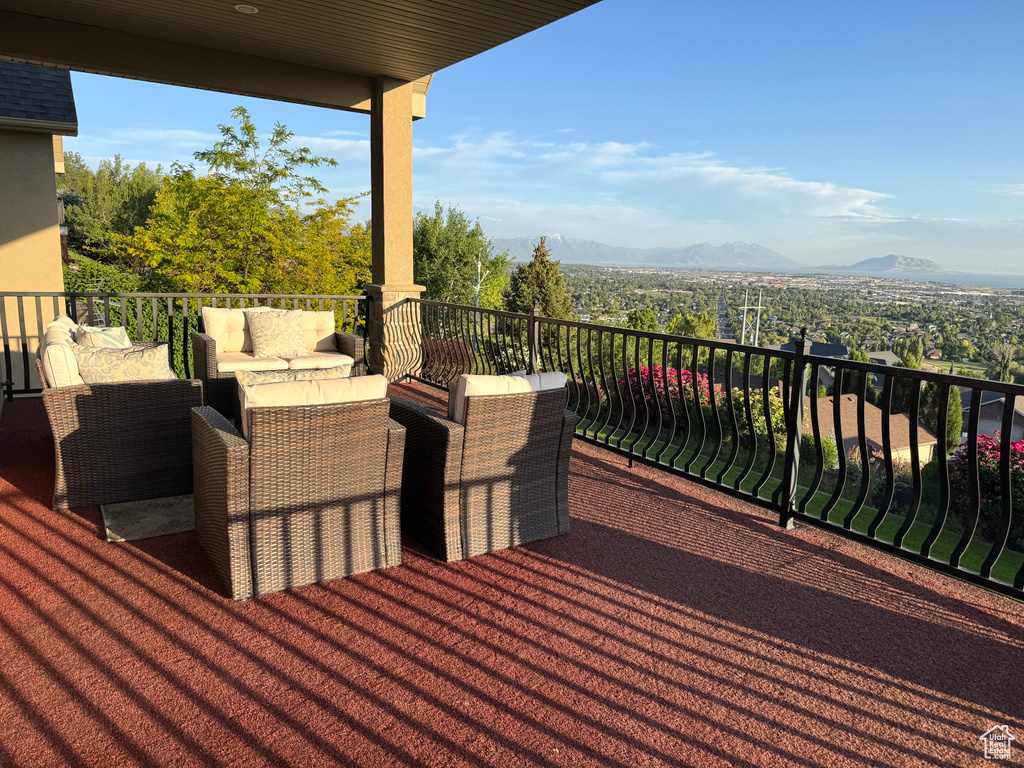 Wooden deck featuring an outdoor hangout area and a mountain view