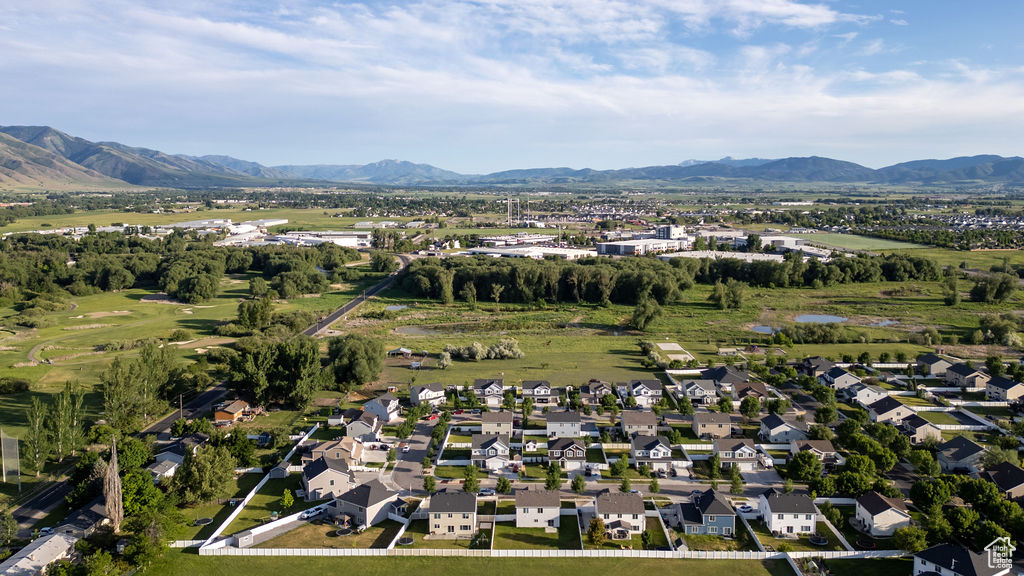 Aerial view of property's location with mountains and nearby suburban area