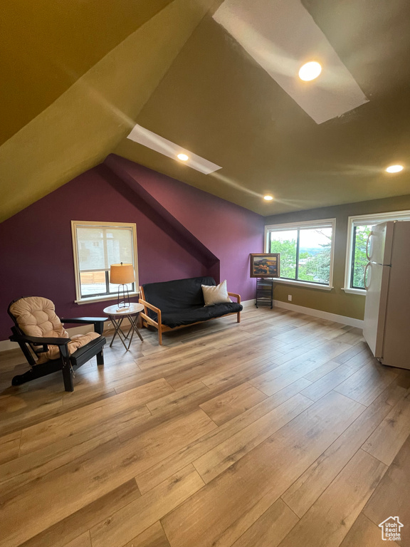 Sitting room featuring lofted ceiling, recessed lighting, hardwood / wood-style flooring, and baseboards