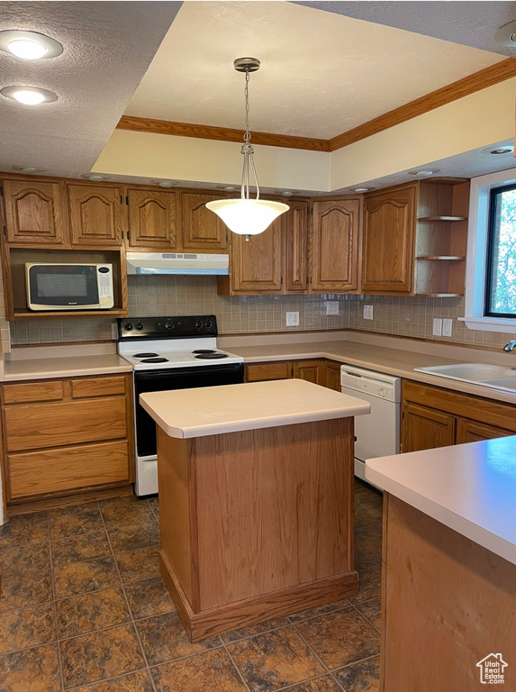 Kitchen featuring white appliances, under cabinet range hood, open shelves, tasteful backsplash, and crown molding
