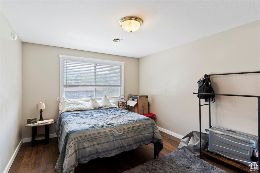 Bedroom featuring baseboards and wood finished floors