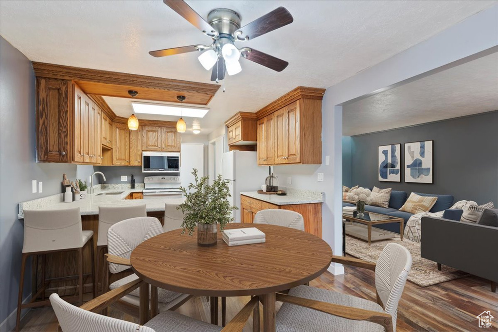 Dining room featuring wood finished floors and ceiling fan