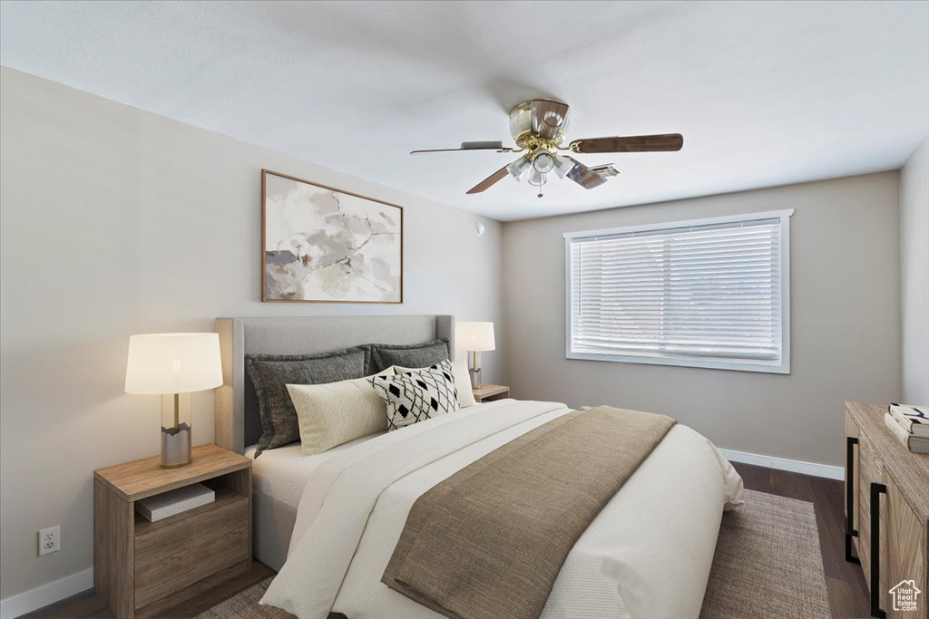 Bedroom with baseboards, dark wood finished floors, and a ceiling fan