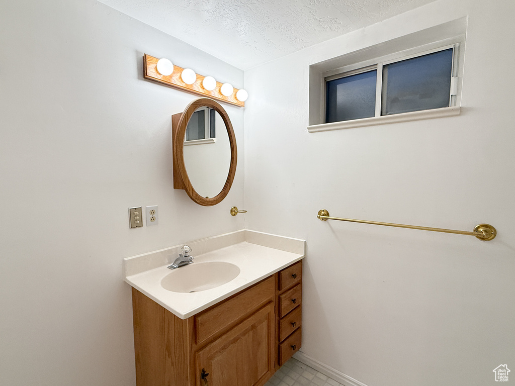 Bathroom with vanity and a textured ceiling