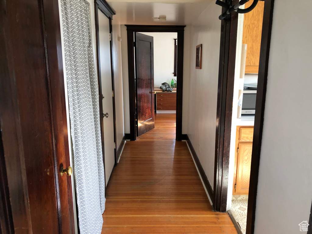 Hallway with light wood finished floors and baseboards