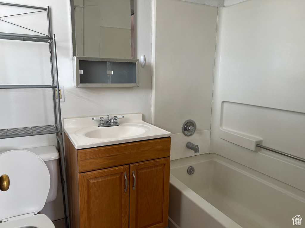 Full bathroom featuring toilet, vanity, and bathing tub / shower combination