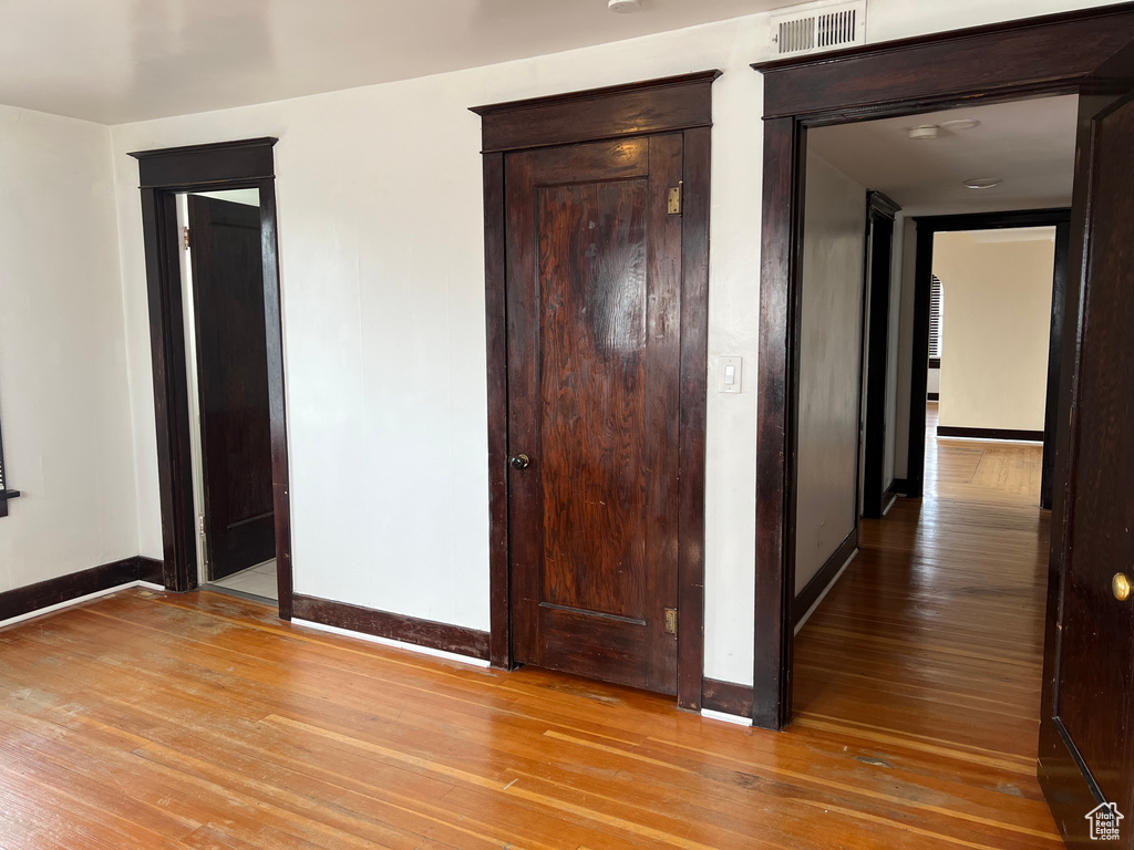 Unfurnished bedroom featuring baseboards and light wood-style flooring