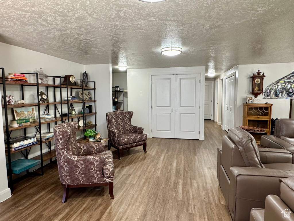 Living room with wood finished floors and a textured ceiling