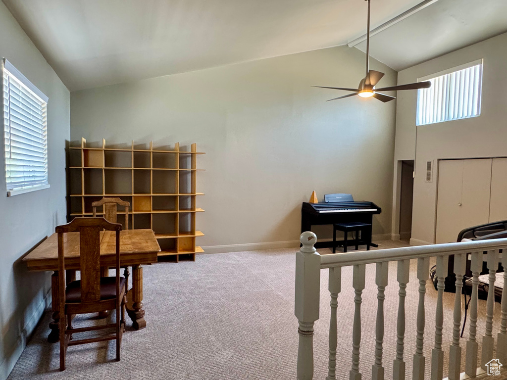 Carpeted bedroom with high vaulted ceiling and baseboards