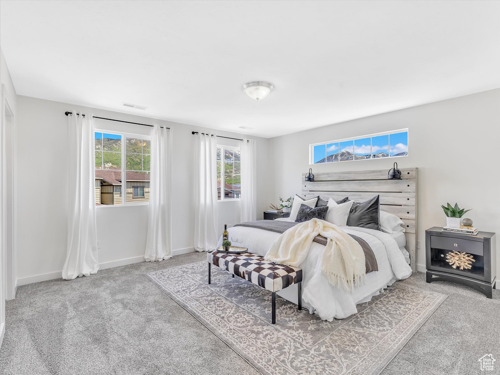 Carpeted bedroom featuring baseboards