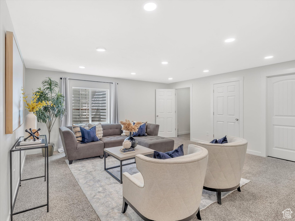 Living room featuring light colored carpet, recessed lighting, and baseboards