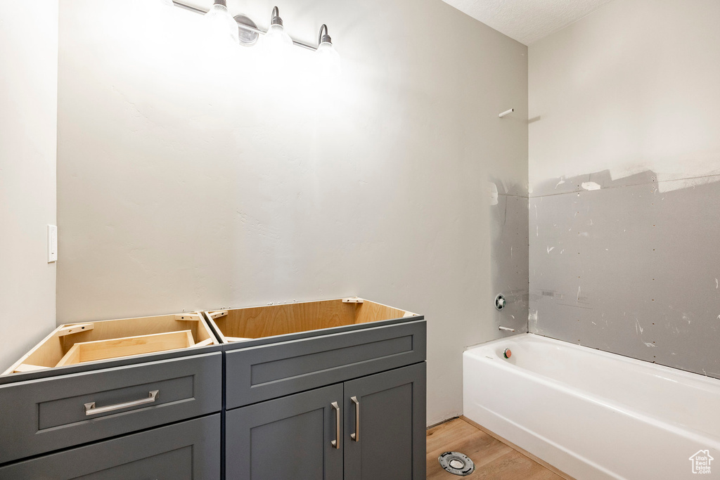 Full bath featuring wood finished floors