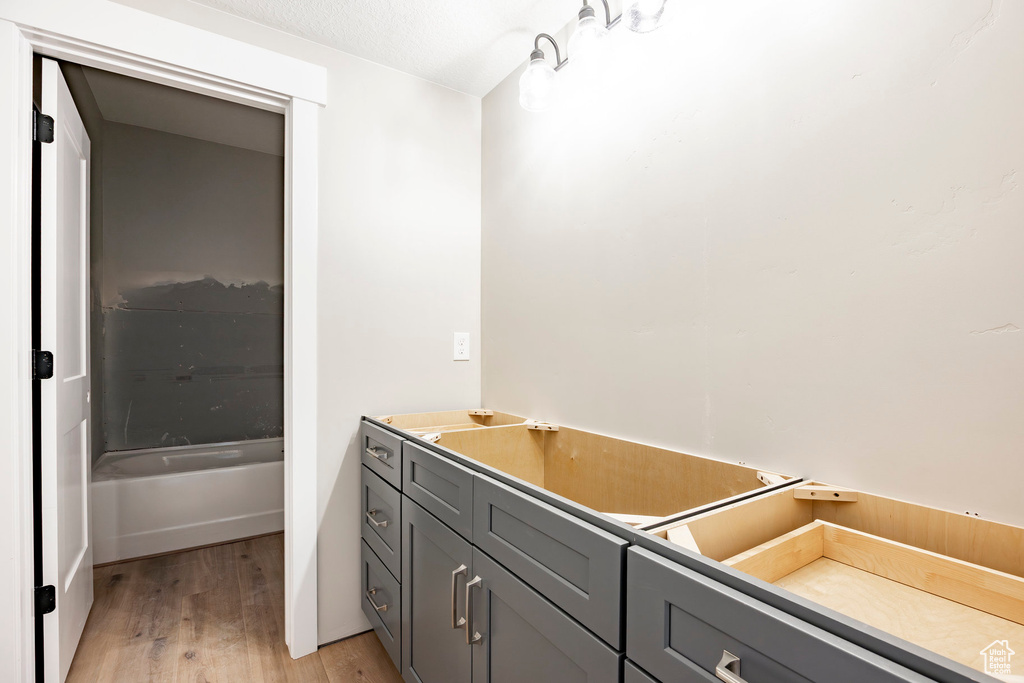 Bathroom featuring wood finished floors and a bath
