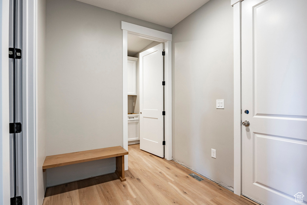 Corridor featuring light wood-type flooring
