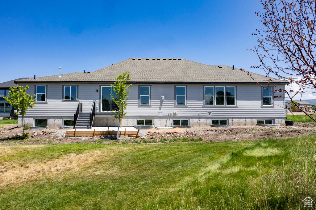 Back of house featuring a yard