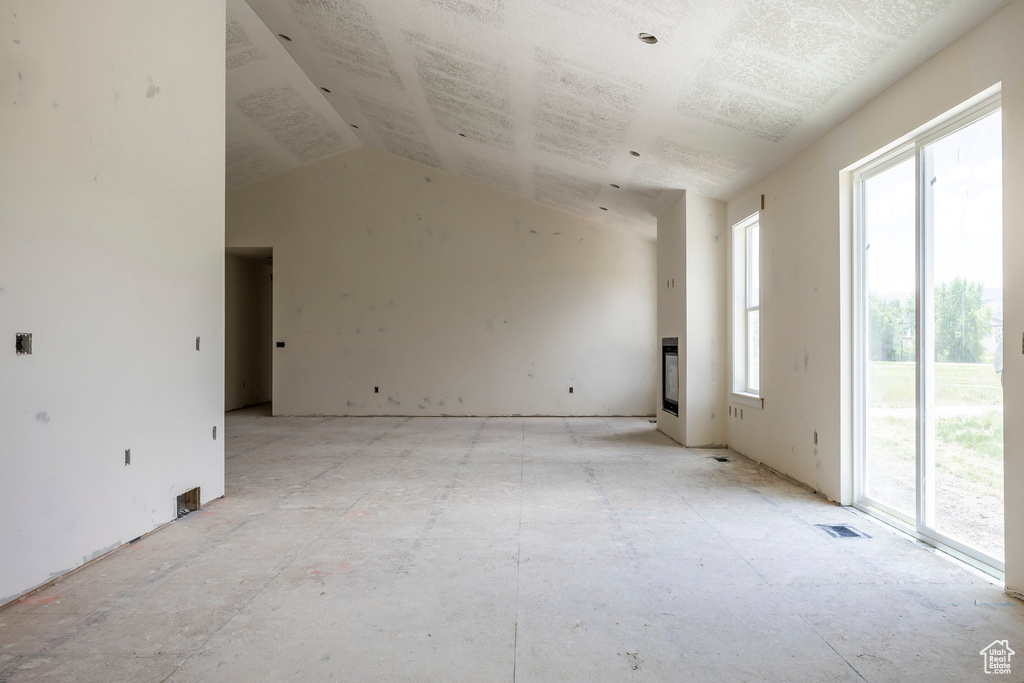 Unfurnished room featuring lofted ceiling