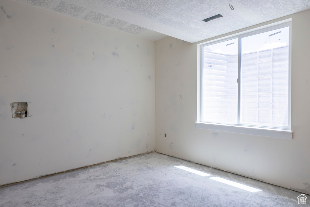 Unfurnished room with a textured ceiling